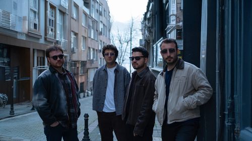 Free Four men wearing sunglasses stand in an urban alley in Istanbul. Stock Photo