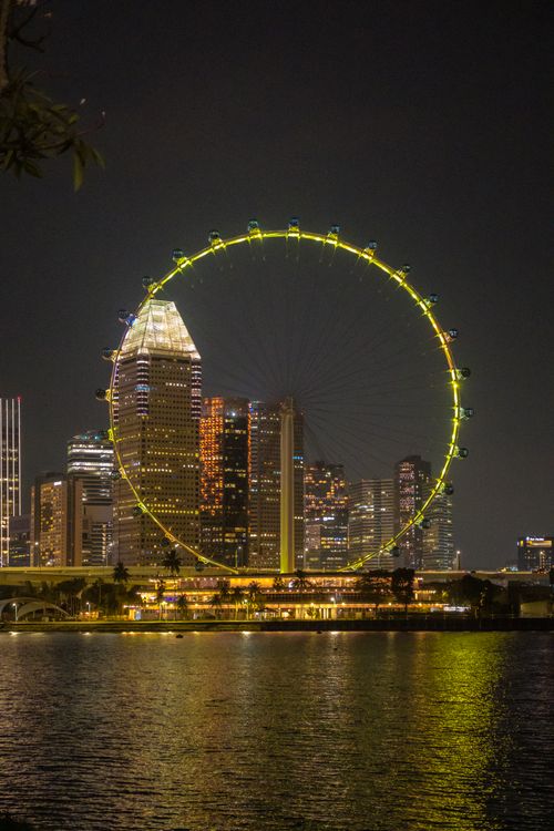 Free Night view of Singapore Flyer and city skyline reflecting on Marina Bay. Stock Photo