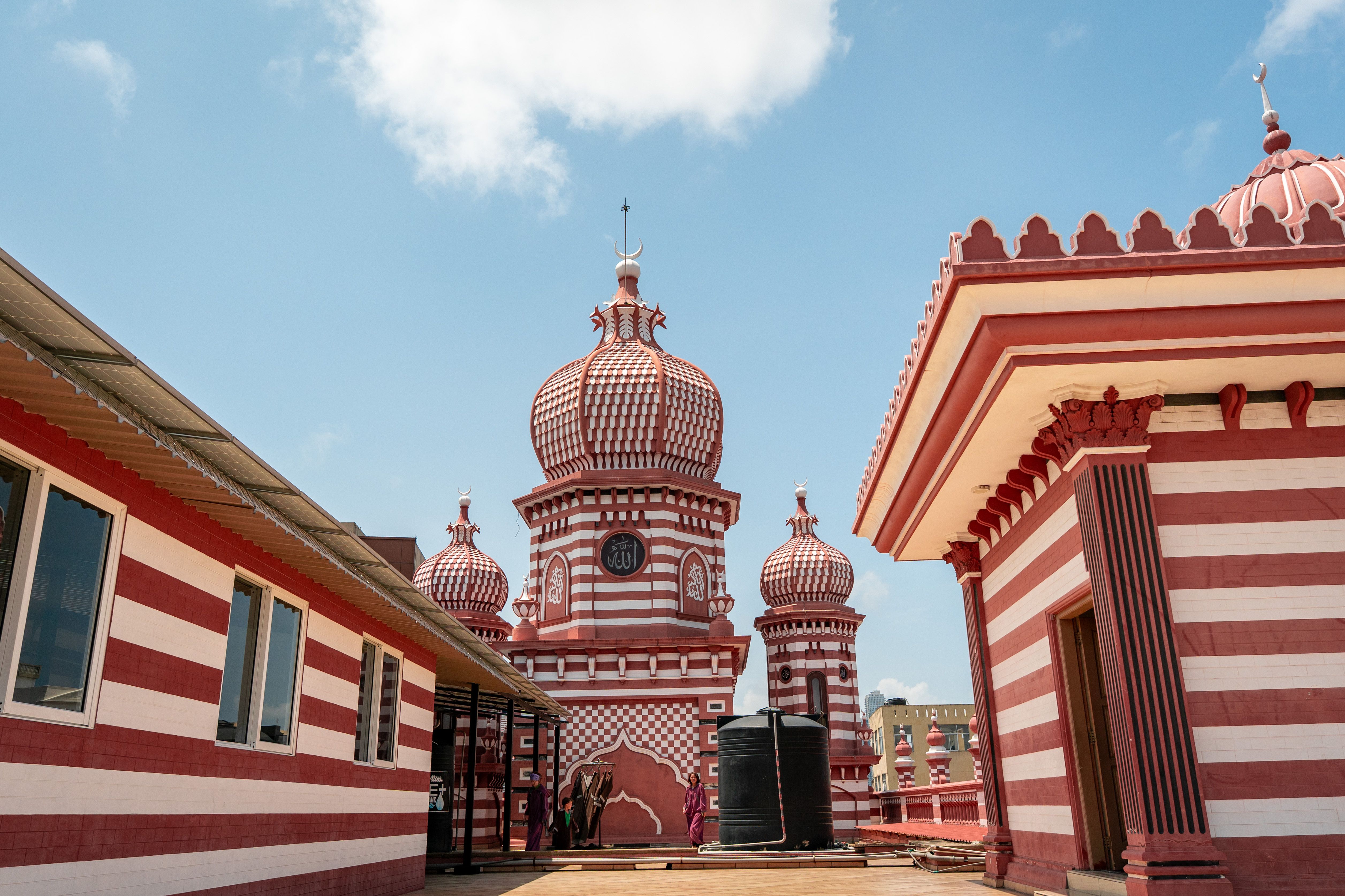 Red and white striped domes of Jami Ul-Alfar Mosque, a striking architectural landmark in Colombo, Sri Lanka.
