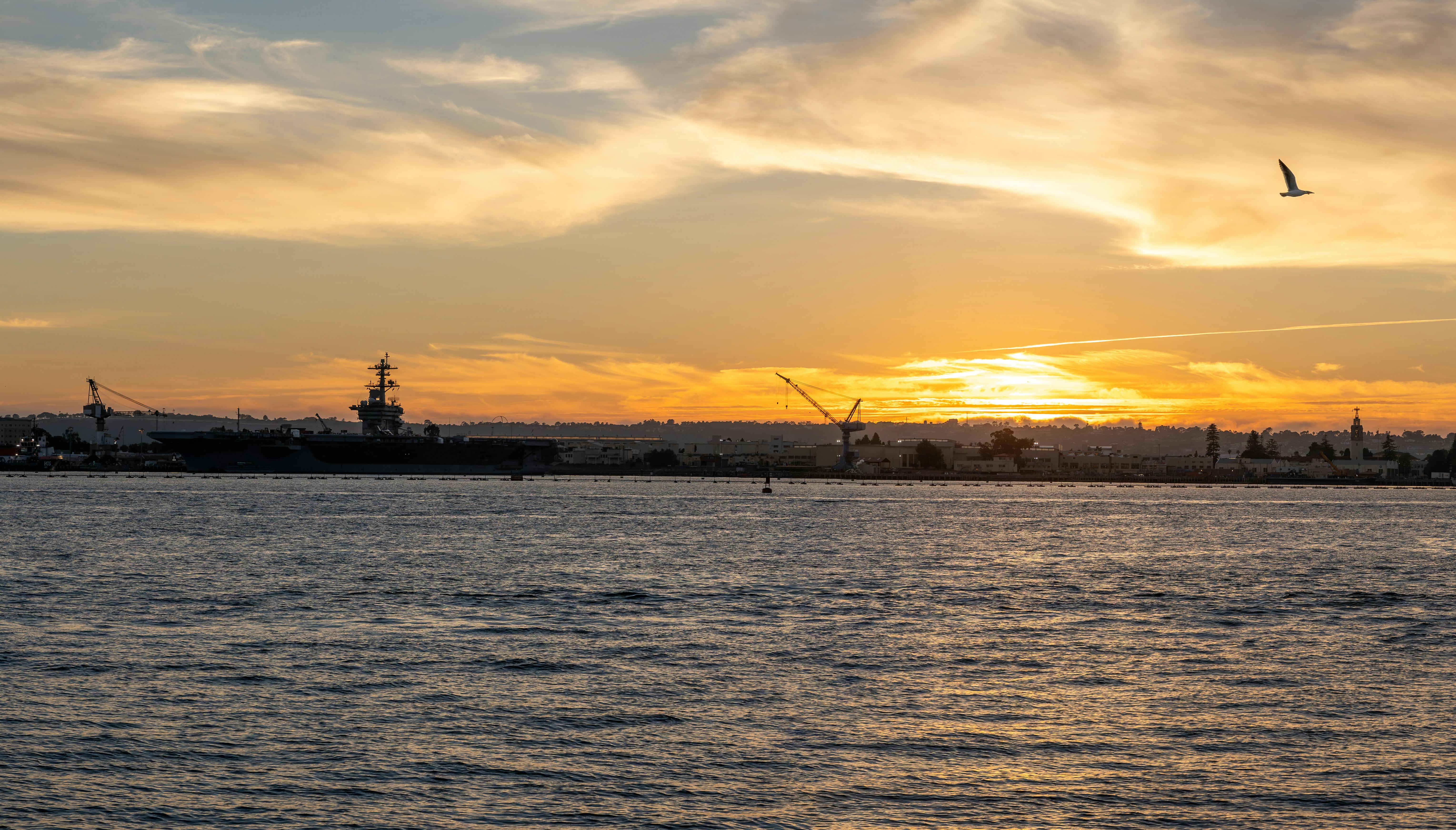 U.S. aircraft carrier strike group moving through the Persian Gulf at sunset