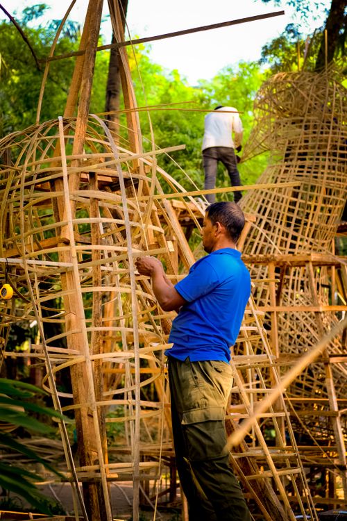 Free Craftsmen constructing large bamboo frameworks in an outdoor setting, showcasing traditional techniques. Stock Photo