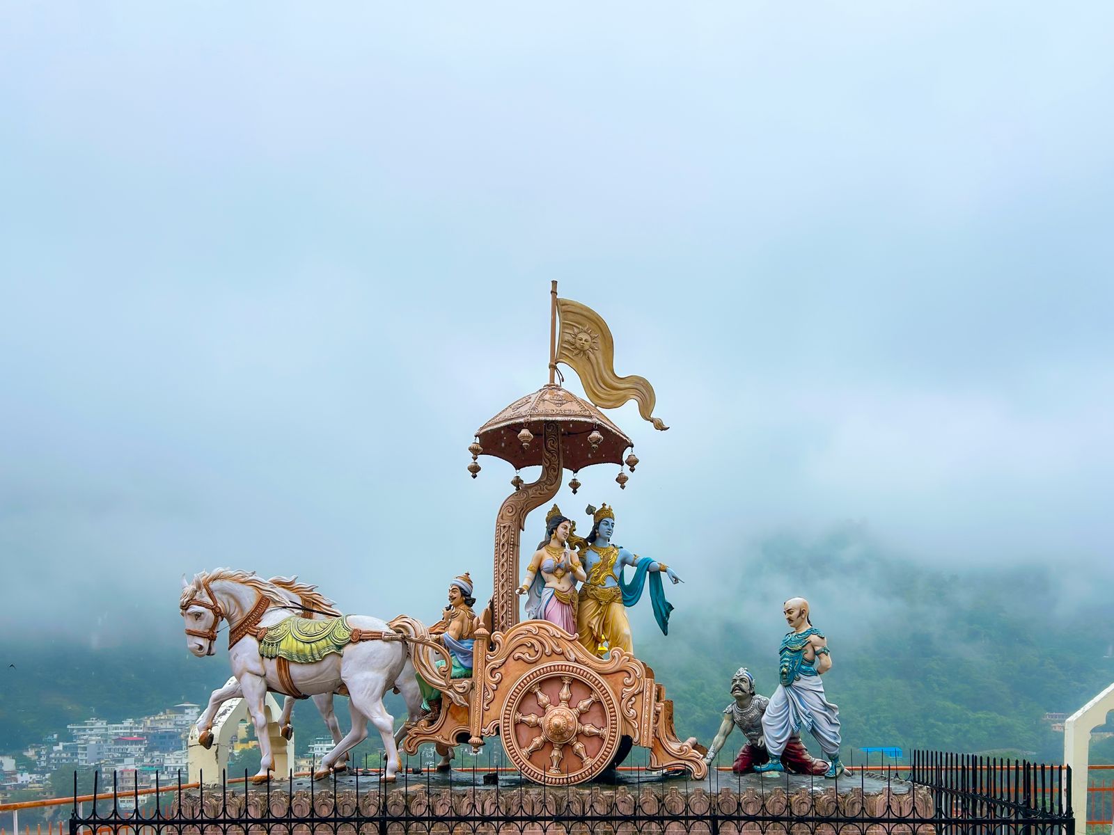 Sculpture of Krishna and Arjuna on a chariot in Rishikesh, India, depicting the Bhagavad Gita's teaching of karma yoga
