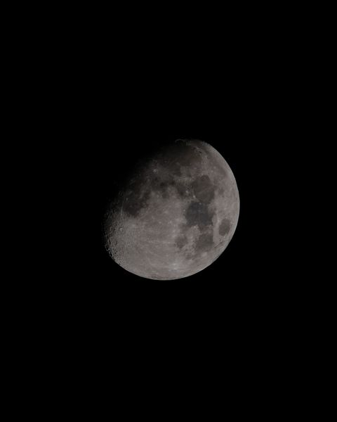 A bright gibbous Moon with its seas and craters clear against a black sky