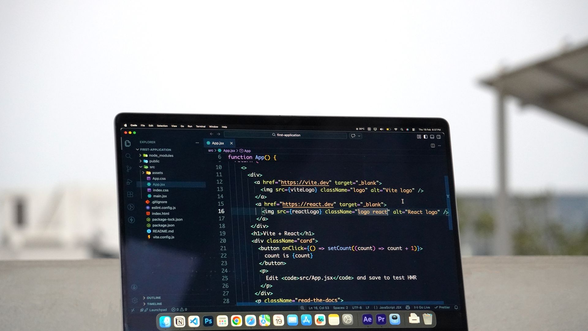 MacBook Pro displaying code on an outdoor terrace in Surat, India, showcasing remote work lifestyle — goog vs googl