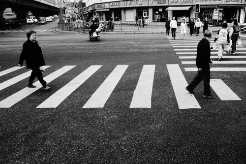 Free Monochrome street scene capturing people crossing a busy intersection in Sichuan, China. Stock Photo