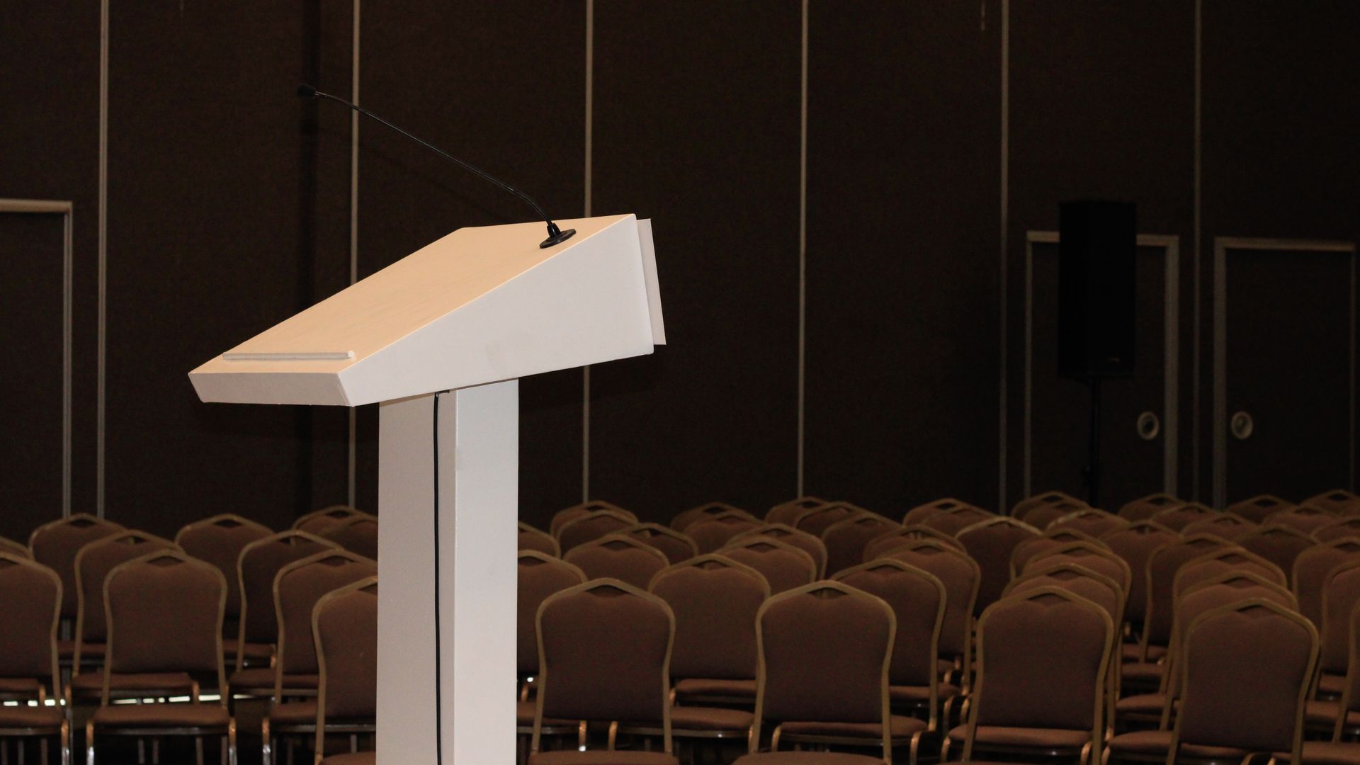 Modafinil for Public Speaking: Unleash Your Oratorical Potential An empty conference room setup with podium and rows of chairs, ready for an event — modafinil for public speaking