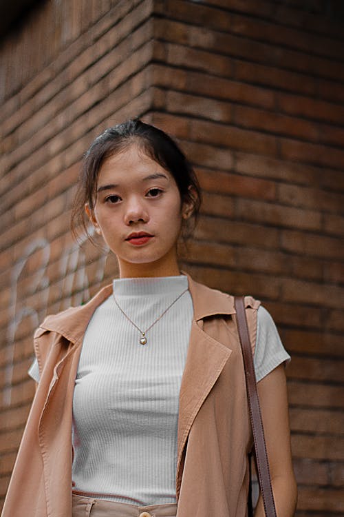 Girl in White Pullneck and Brown Sleeveless Jacket