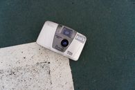 A classic Canon camera laying on a textured outdoor surface in Istanbul.