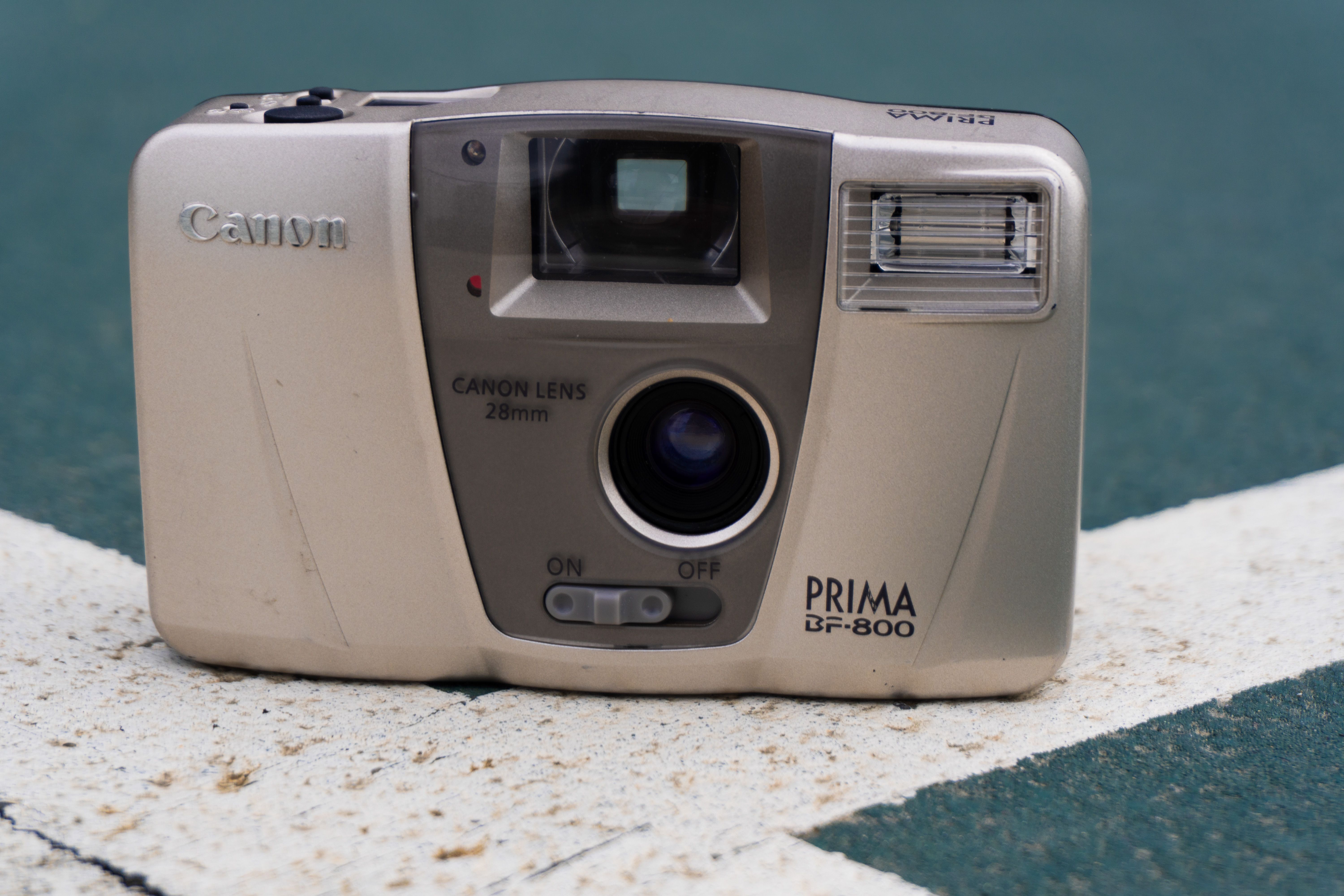 Vintage Canon Prima BF-800 Camera on Urban Background · Free Stock Photo