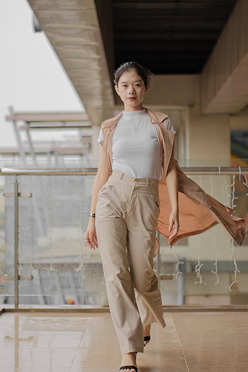 Photo of Woman Wearing White Top and Beige Pants