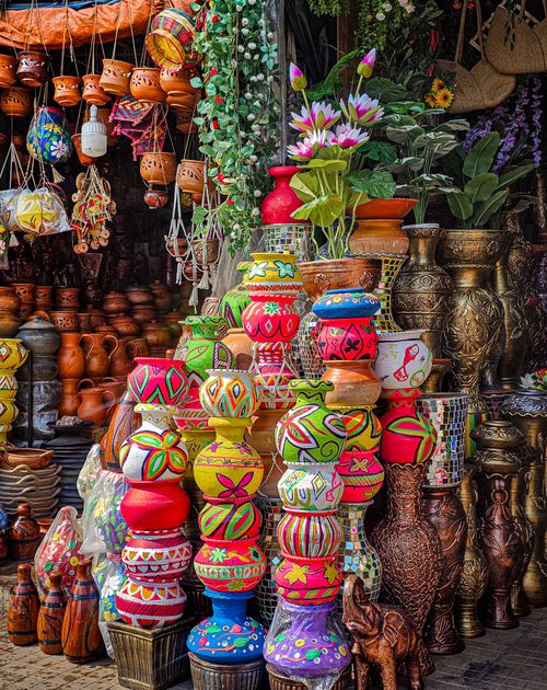 Free Vibrant assortment of painted clay pots at an artisan market full of diverse patterns and textures. Stock Photo