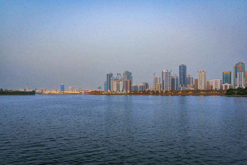 Photo: Siarhei Nester / Pexels The Sharjah skyline reflected on water at dusk