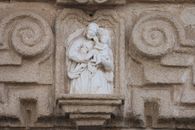 Intricate stone relief depicting a religious scene from El Puerto de Santa María, Spain.