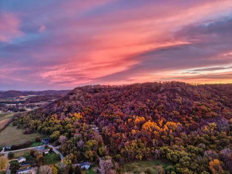 Beautiful aerial view of colorful autumn trees under a vibrant sunset in Nelson, Wisconsin.