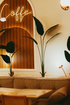 Stylish cafe interior with warm lighting and trendy decor features.