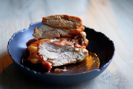 High-quality image of tender, juicy chicken pieces in a dark blue bowl, perfect for culinary use.