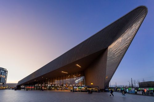 Free Evening view of Rotterdam Centraal Station's unique design and bustling urban life. Stock Photo