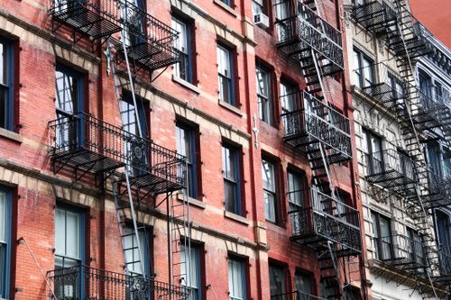 Free Iconic New York style brick facade with fire escapes, capturing urban architecture. Stock Photo