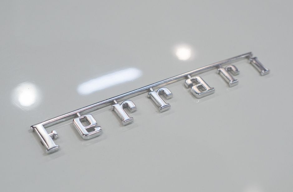 High-quality image of a luxury car emblem on a shiny metallic surface, showcasing automotive elegance.
