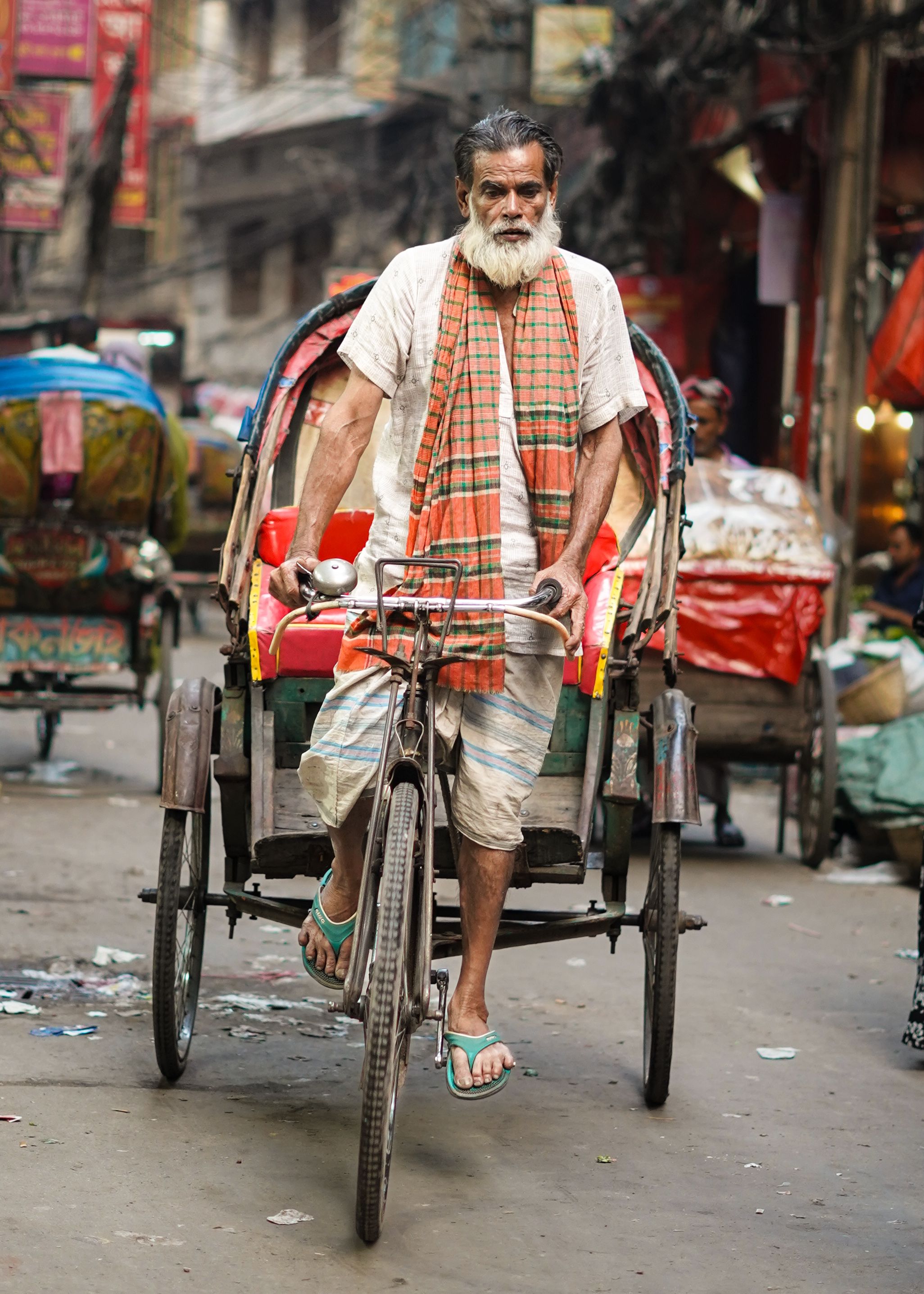Hasan Reksha Elderly Man Riding a Traditional Rickshaw in Dhaka · Free Stock Photo
