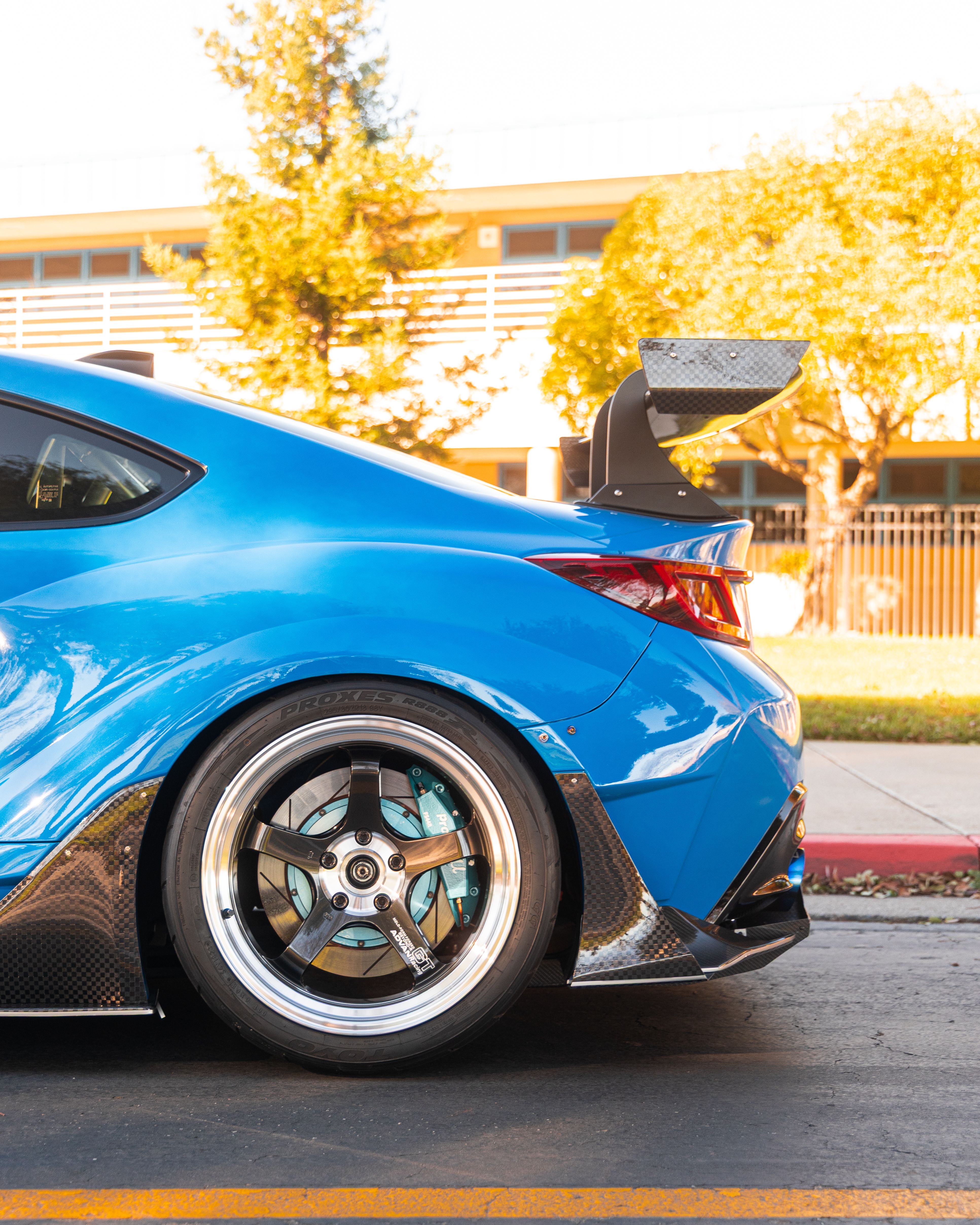 Close-up of a customized blue sports car with carbon fiber details in Tracy, CA.
