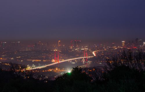 Free Stunning view of a city skyline and illuminated bridge at night, showcasing urban lights. Stock Photo