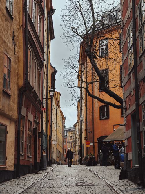 Free A picturesque street in Stockholm's historic Gamla Stan with colorful buildings. Stock Photo