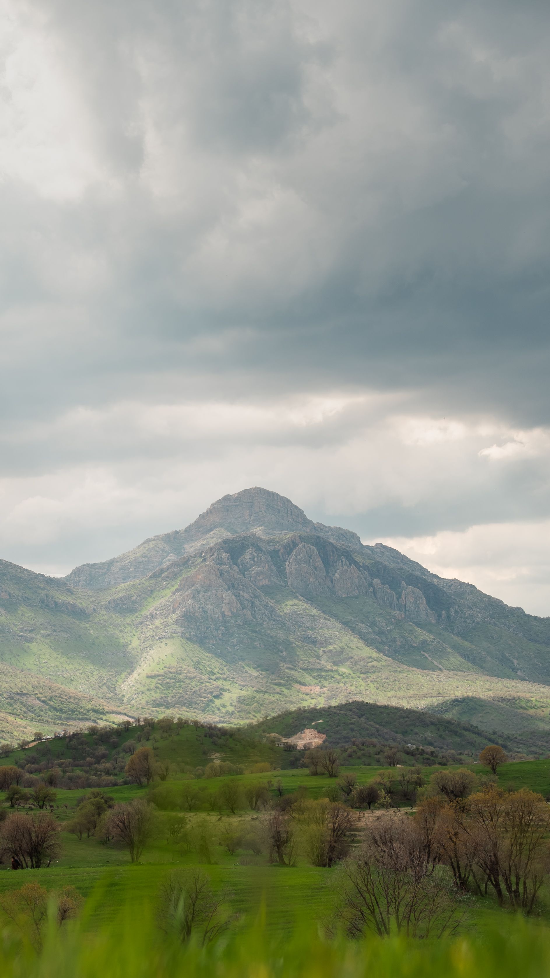 Majestic mountain landscape in Iraq during springtime, captured under dramatic skies.