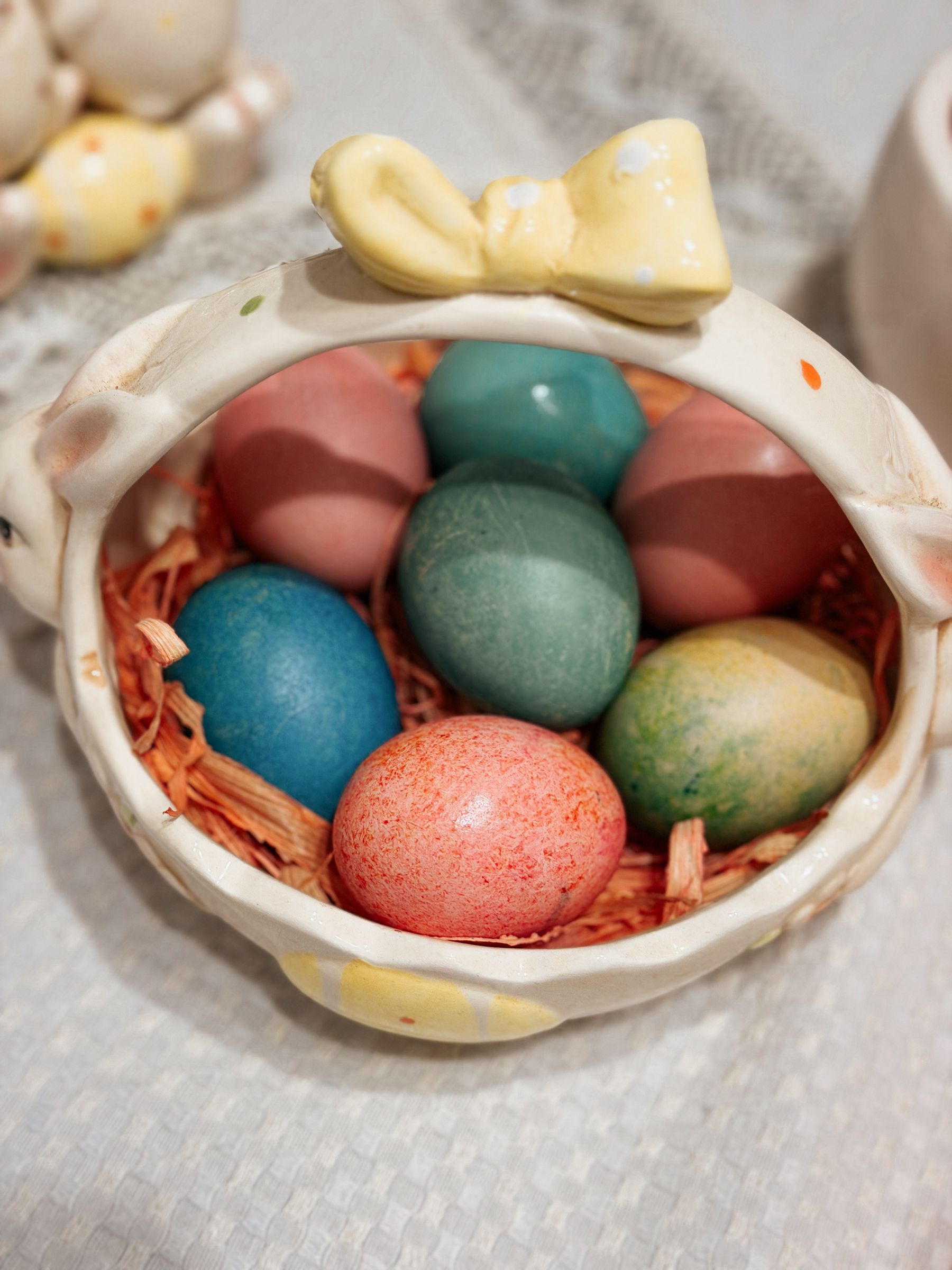 Bright multicolored Easter eggs grouped in a ceramic basket