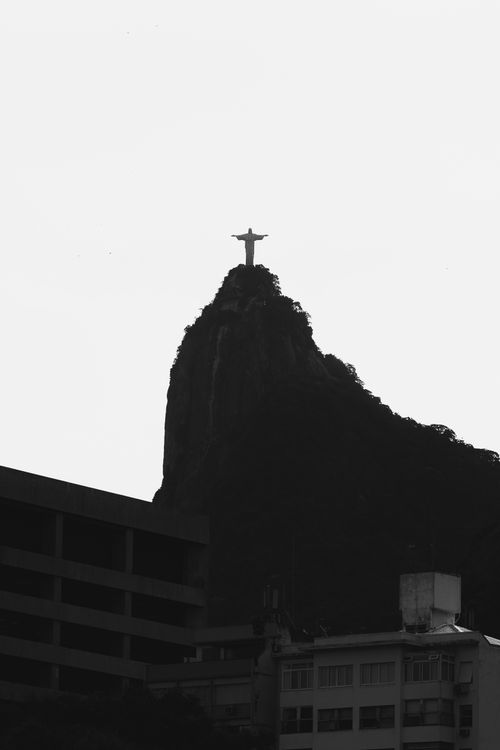 Free Black and white silhouette of Christ the Redeemer atop Corcovado Mountain in Rio de Janeiro. Stock Photo