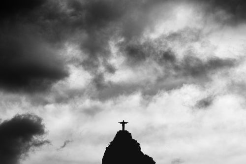 Free Black and white silhouette of Christ the Redeemer statue under dramatic clouds in Rio de Janeiro. Stock Photo