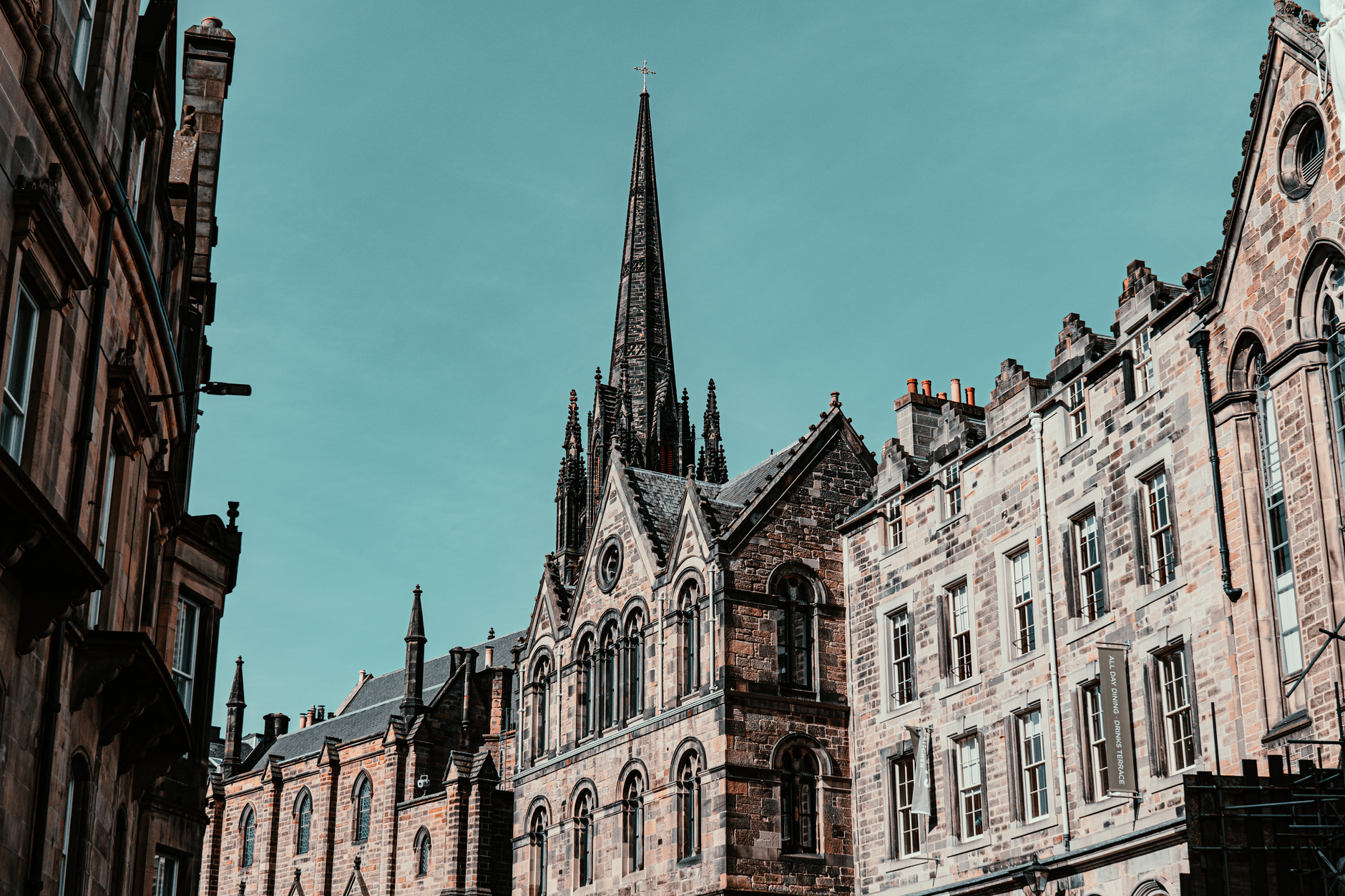 Gothic architecture in Edinburgh featuring tall spires and historic facades under a clear sky., Edinburgh, United Kingdom, stay connected here with a travel eSIM