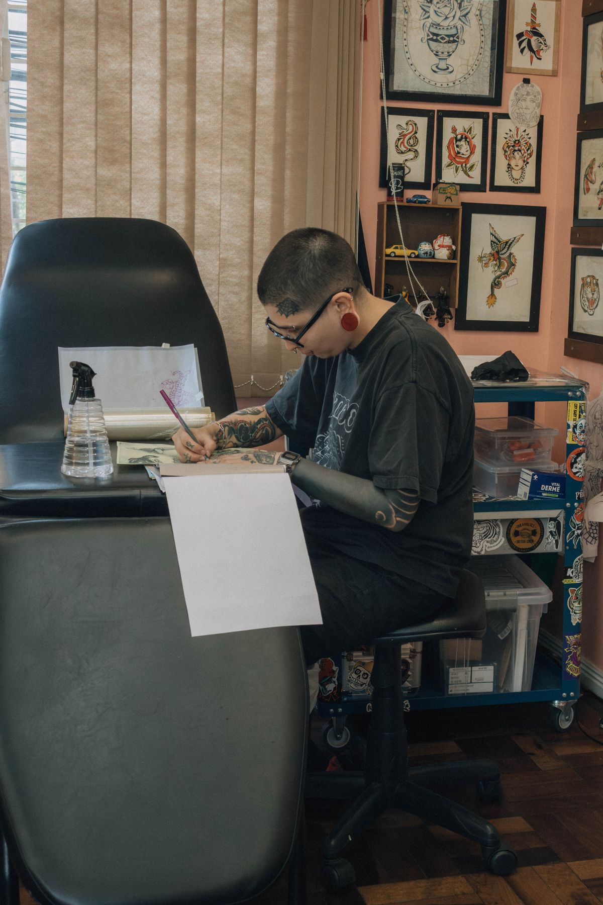 Artist sketching a custom tattoo design at the station