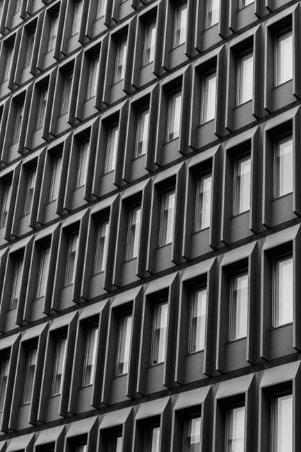 Black and white photo of a geometric building facade in Melbourne, Australia, showcasing modern architecture.