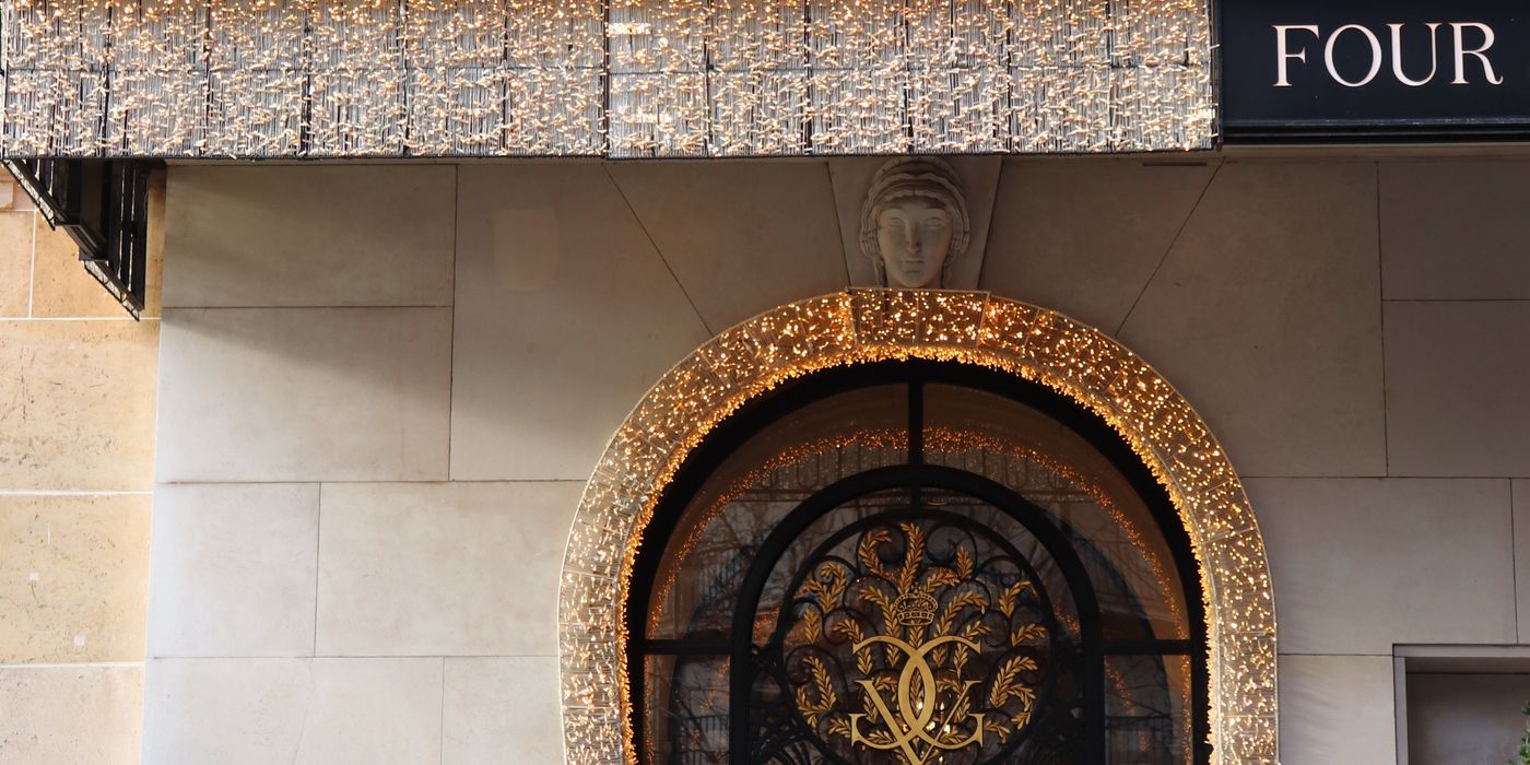 Grand entrance of the Four Seasons Hotel Paris with ornate stone facade and ironwork