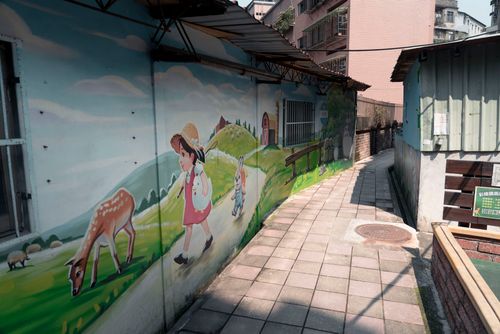 Free A vibrant mural featuring children and animals on a city wall in Taipei. Stock Photo