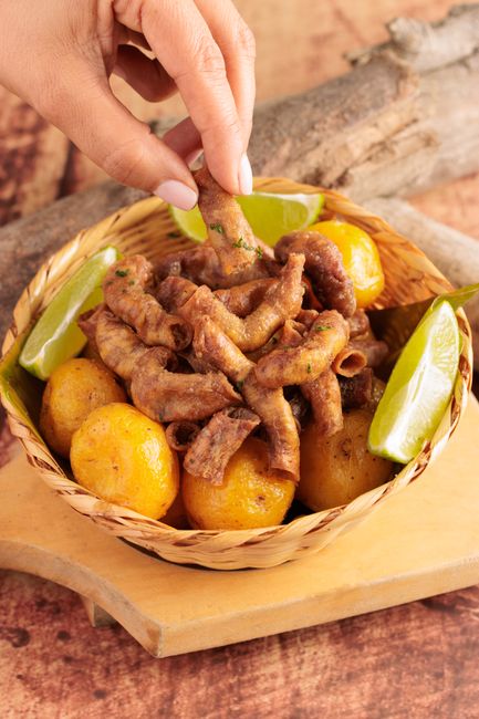 Basket of chinchulines with potatoes and lime, a traditional South American dish. — Enguias fritas, a Portuguese dish.