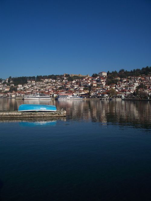 Free Beautiful view of Ohrid's waterfront with clear reflections and vibrant blue sky. Stock Photo