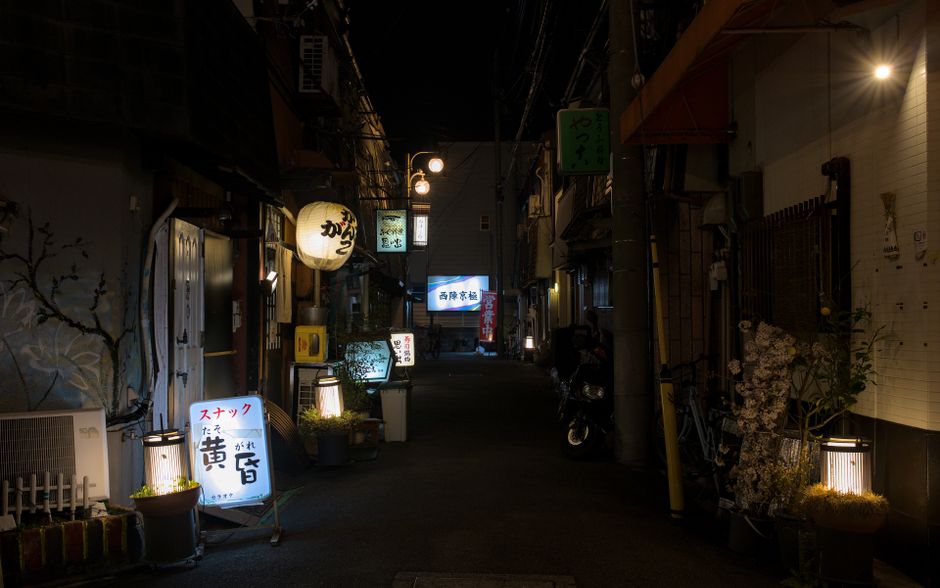 Cheongdam late-night street with low-lit bar entrances and side-alley dining