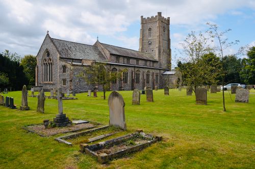 Free A medieval stone church and graveyard under a cloudy sky in England. Stock Photo