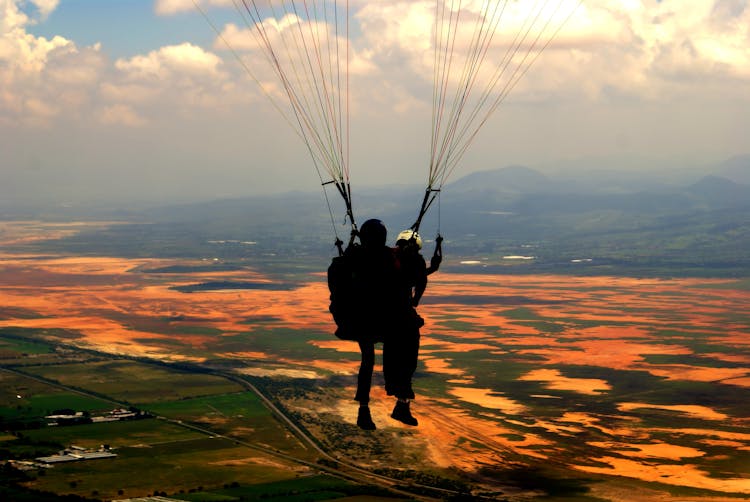 Silhouette Of Person On Parachute During Sunset