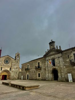 A captivating view of ancient stone buildings in Spain's Lugo Province with cloudy skies.