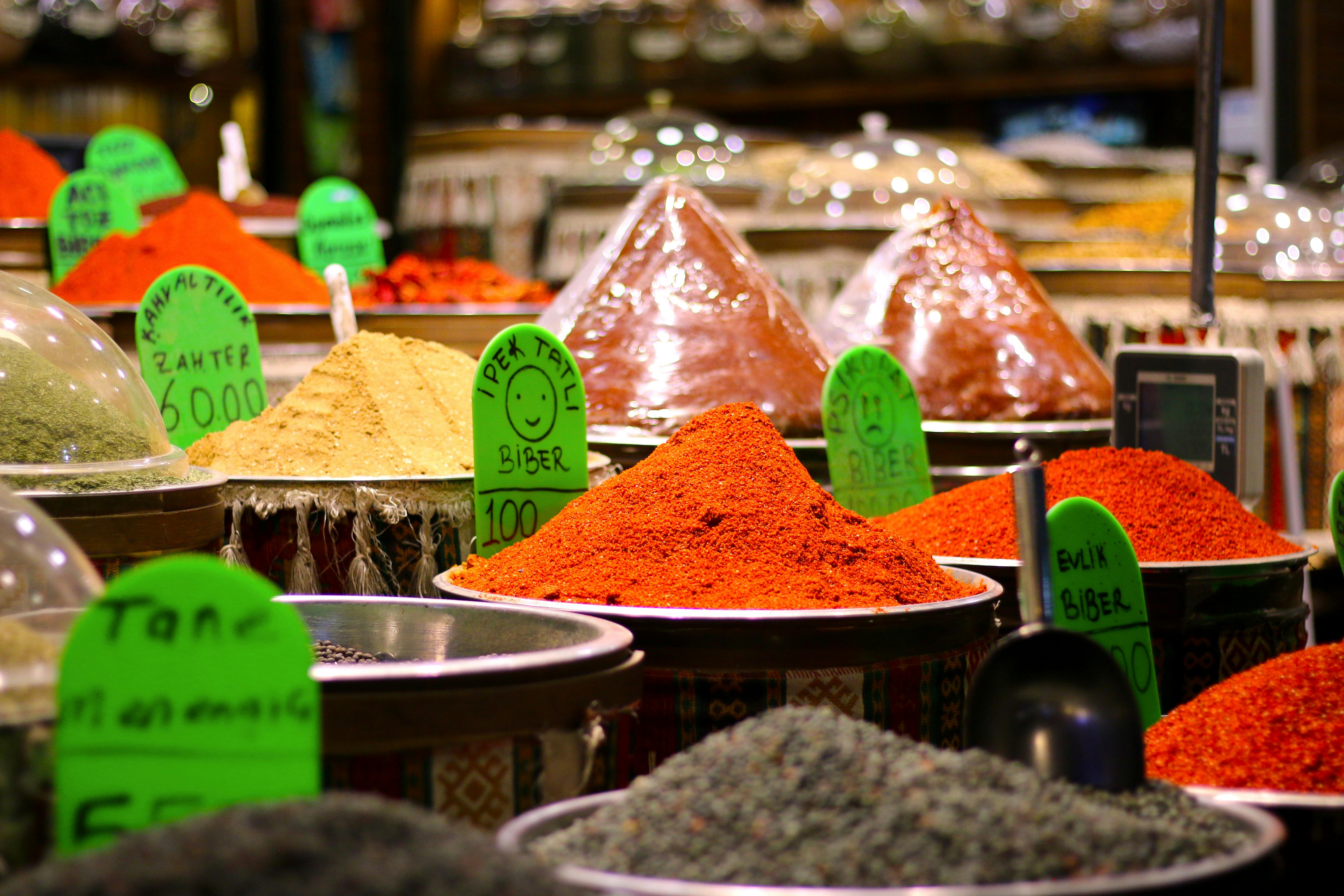 Colorful assortment of spices in Gaziantep market, featuring various chili powders and seasonings.