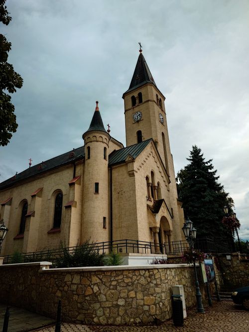Free A picturesque historic church in Tokaj, Hungary, showcasing unique architectural design and towering steeples. Stock Photo