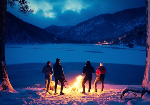 Group of tourists near bonfire in winter highlands