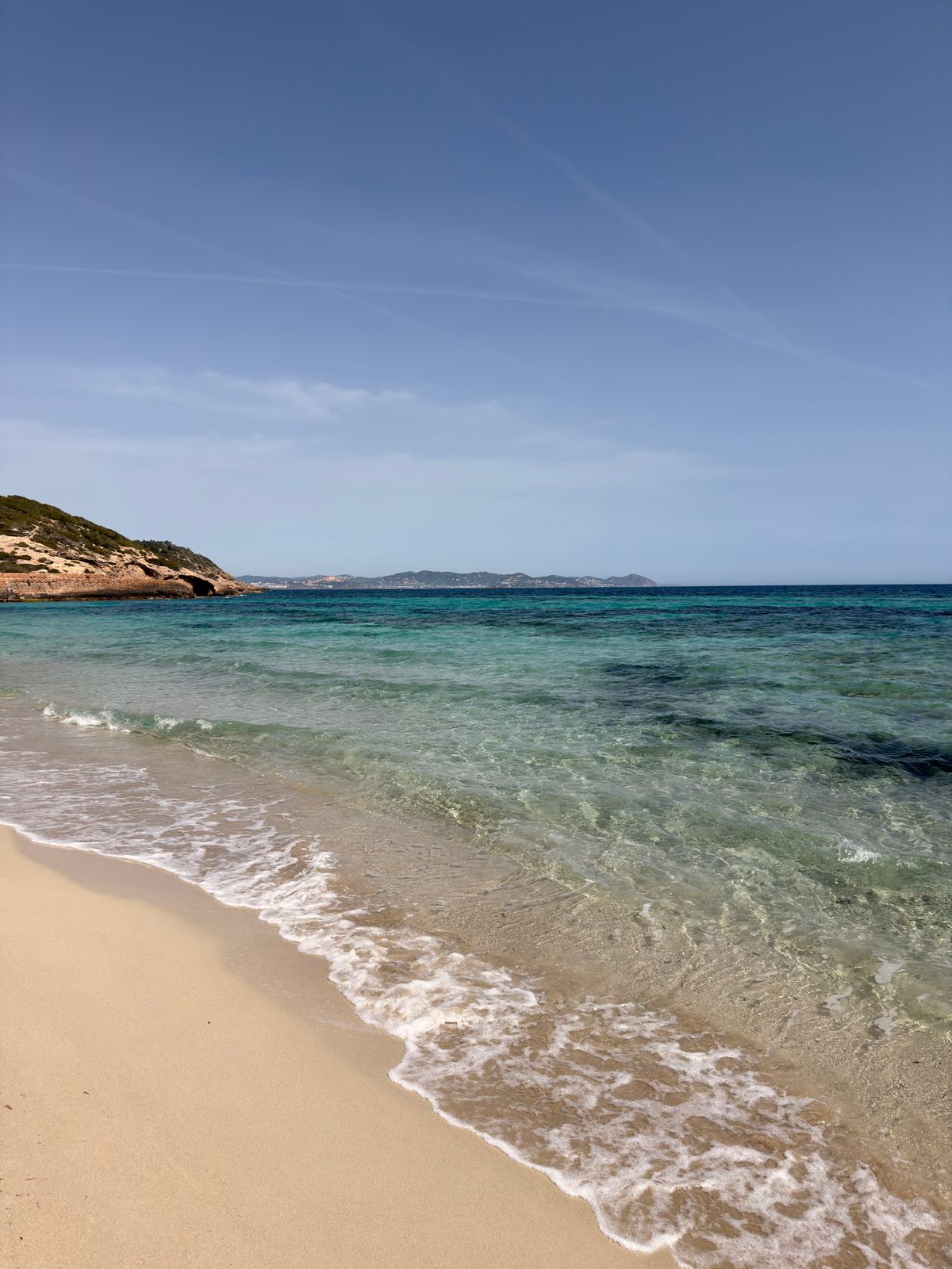 An idyllic Mediterranean beach scene on Ibiza — the white island