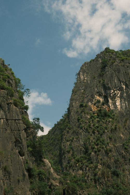 Free Stunning view of high limestone cliffs with greenery under a clear blue sky. Stock Photo