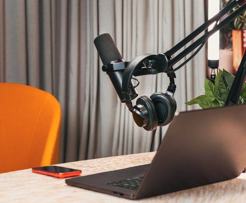 Condenser microphone and headphones in a small audio booth — photo by Jakub Zerdzicki on Pexels