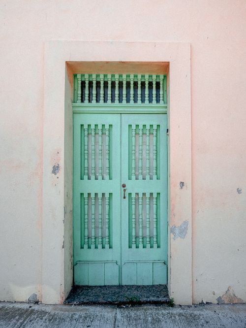 Free A vibrant teal door set within a weathered facade in Malta, showcasing rustic charm and Mediterranean style. Stock Photo