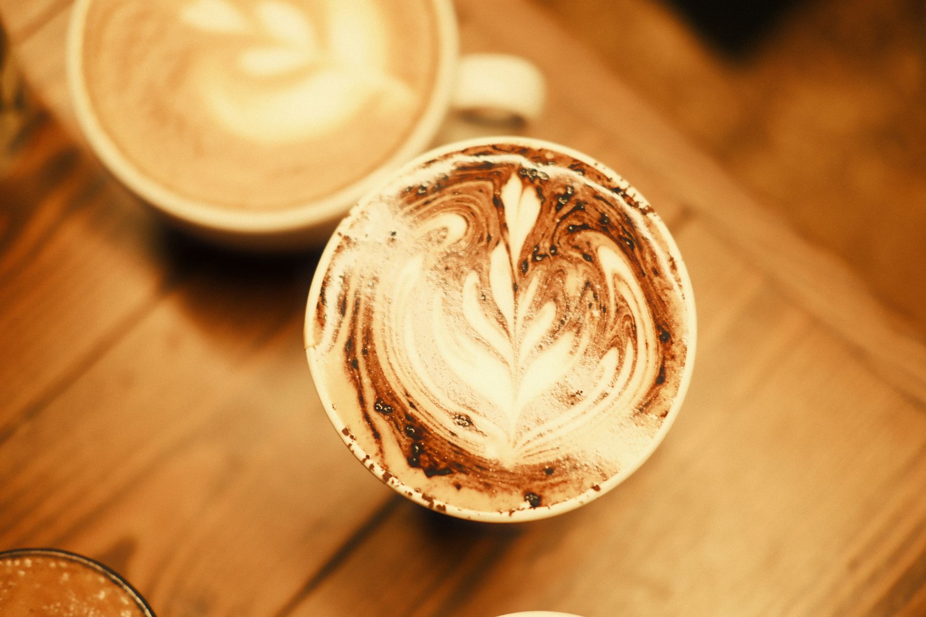 A cup of freshly brewed single-origin coffee on a wooden counter in a highland Honduran town